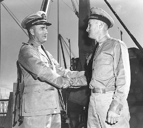 Capt Christie congratulates LCdr Moore