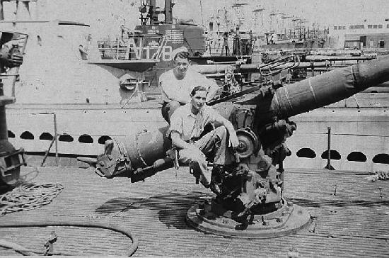 O.V. Johnson and topside watch sitting on deck gun