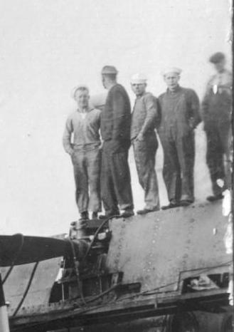 Crew standing on the deck of another submarine underconstruction