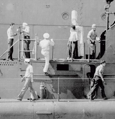 Crews working on equipment, USS PLunger July 22, 1942