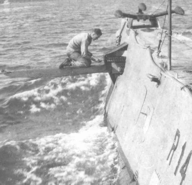 USS R-14 crewman working on bow planes