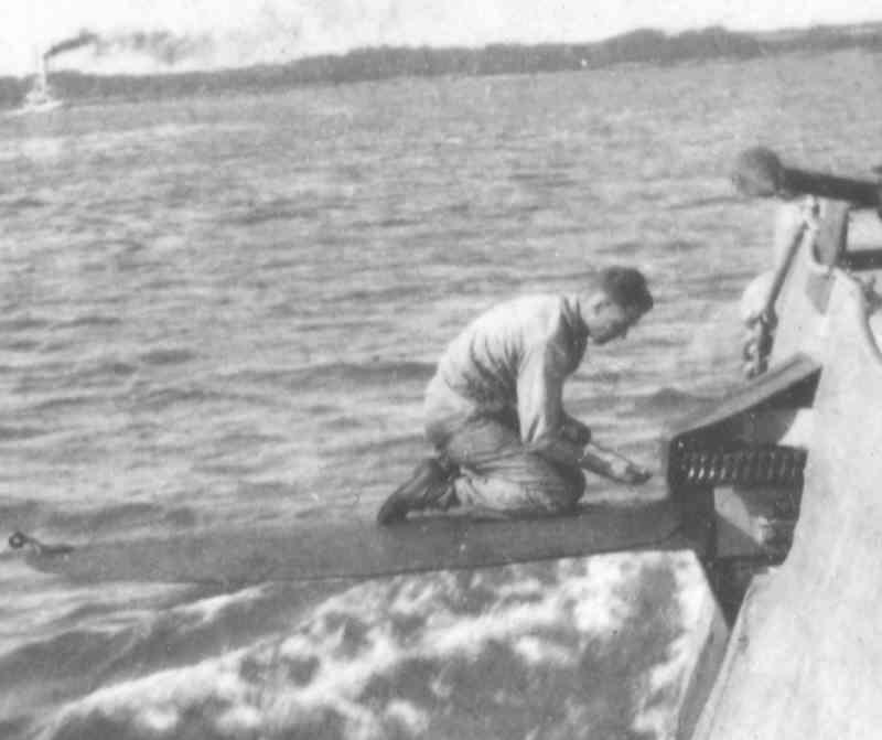 USS R-14 crewman working on bow planes