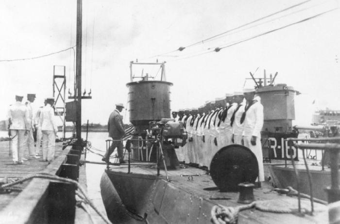 USS R-17 receiving a civilian dignitary. USS R-16 moored outboard.