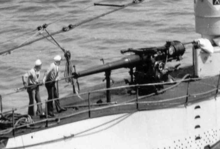 S-26 sailors cleaning deck gun barrel.